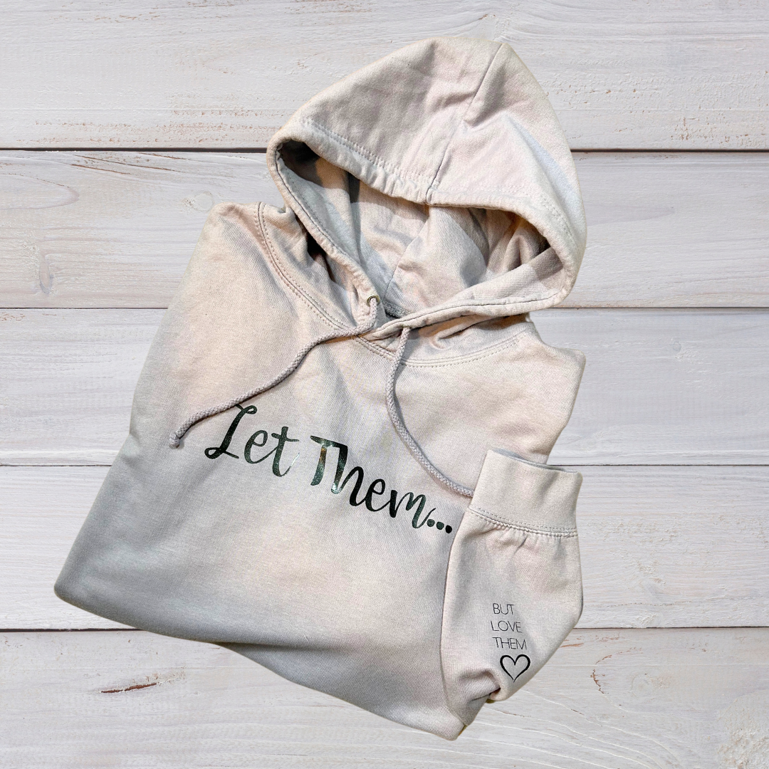 Folded Let Them Hoodie in Dusty Lilac with black lettering on front and sleeve